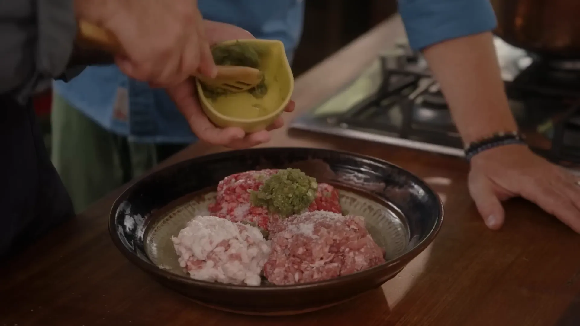 Preparing the minced meat filling for Khinkali with fresh coriander and spices