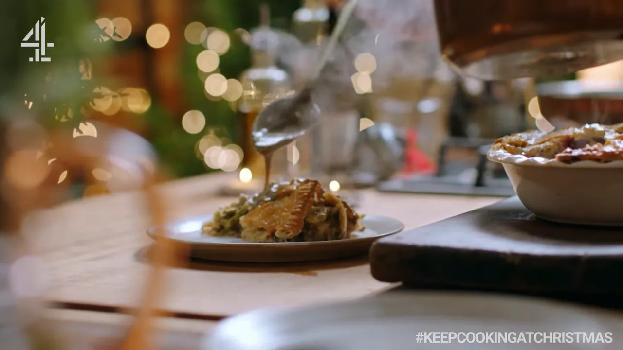 slice of hodgepodge pie on a plate with gravy being poured over it