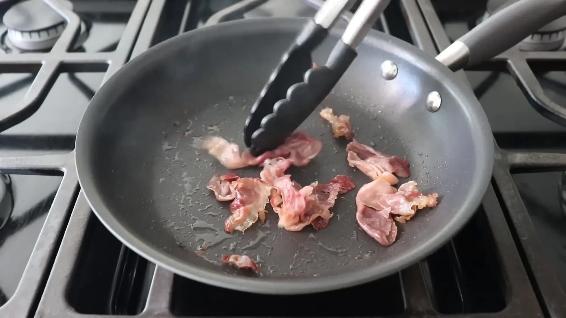 Pulling two-thirds of the lightly browned prosciutto onto a plate to reserve