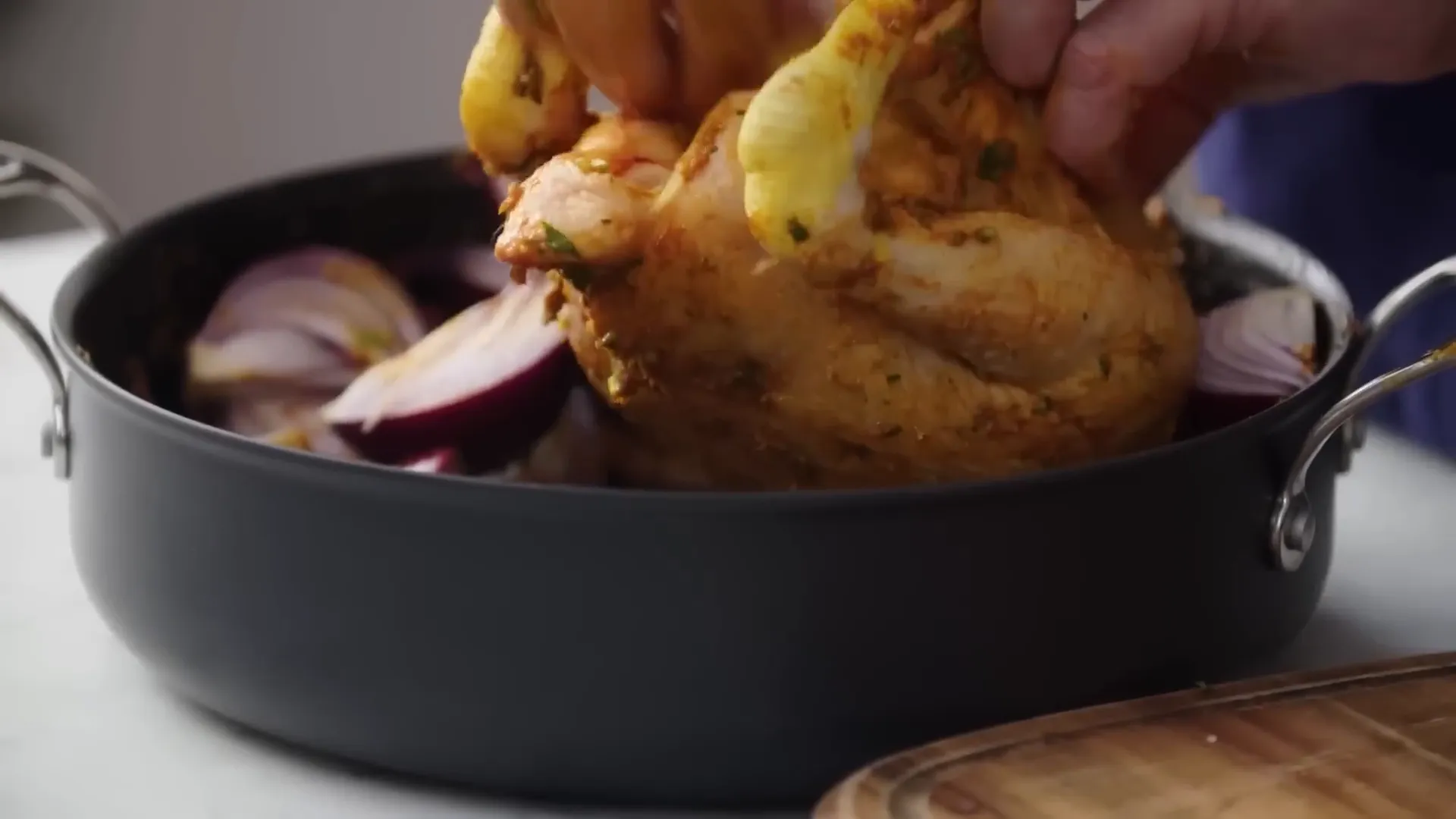 Chicken being massaged with fragrant curry paste and herbs