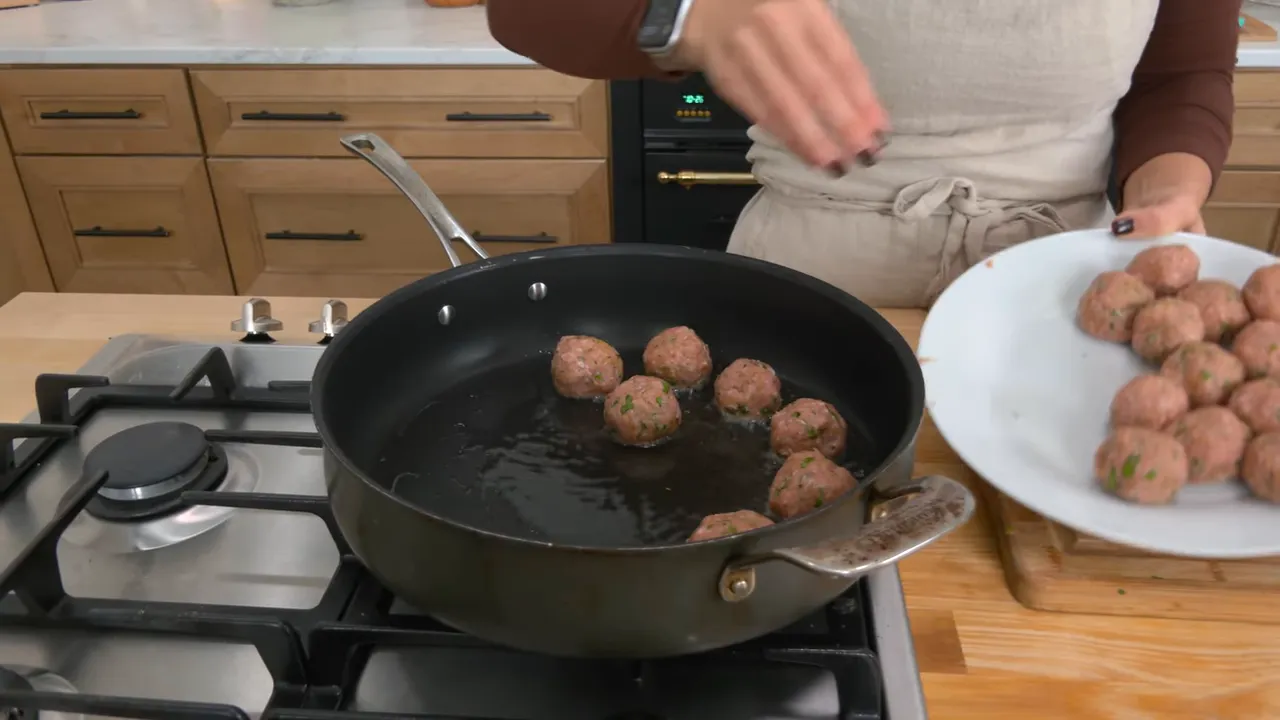 Meatballs browning in olive oil