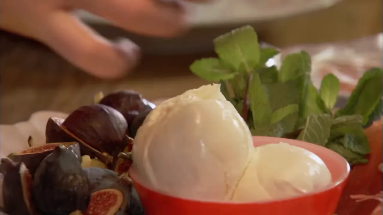 mozzarella balls in a bowl with figs and fresh mint for canapés