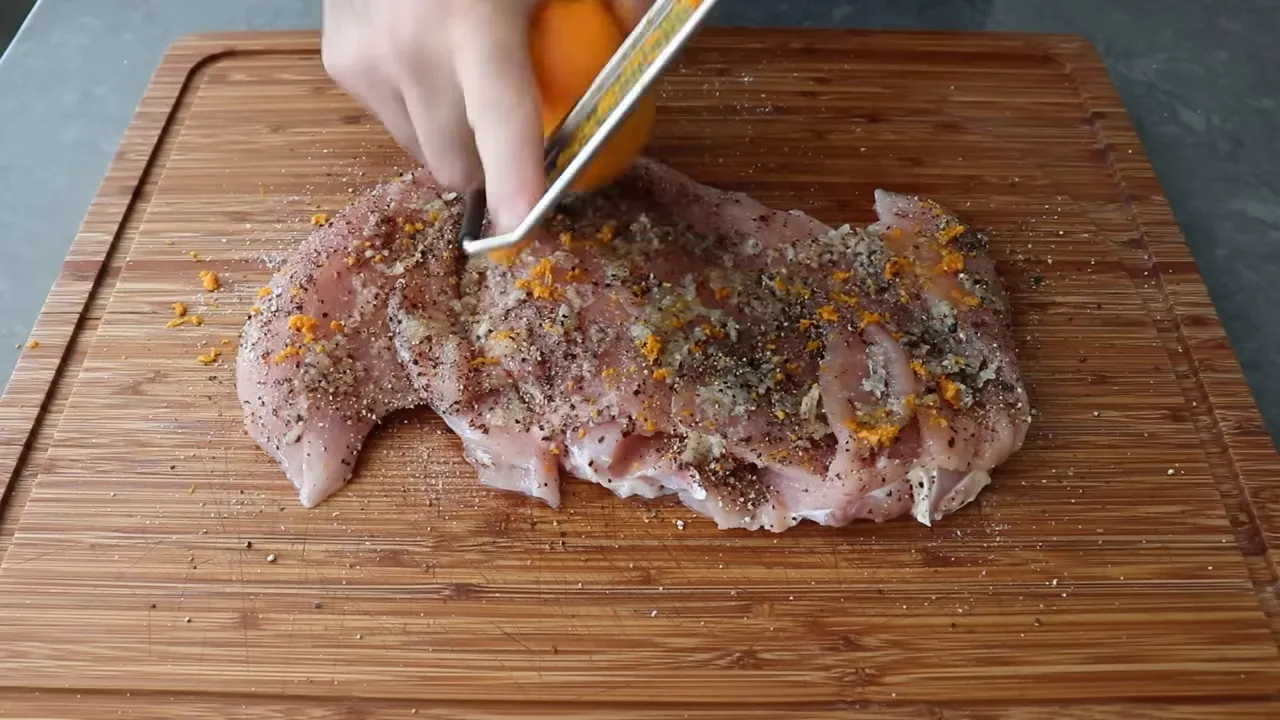 Seasoning the butterflied turkey with garlic and citrus zest