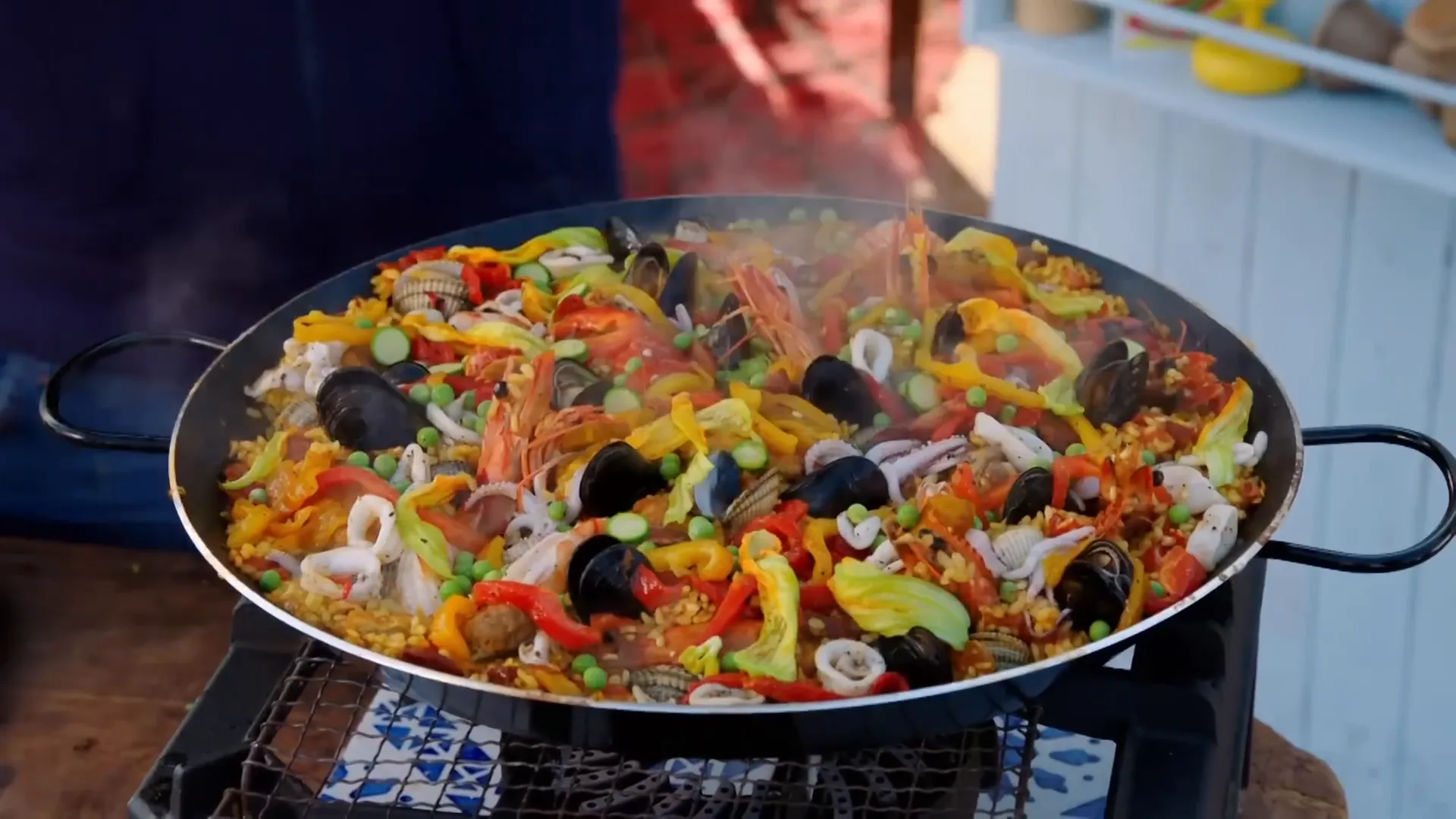 Finished paella in the pan, seafood and socarrada visible