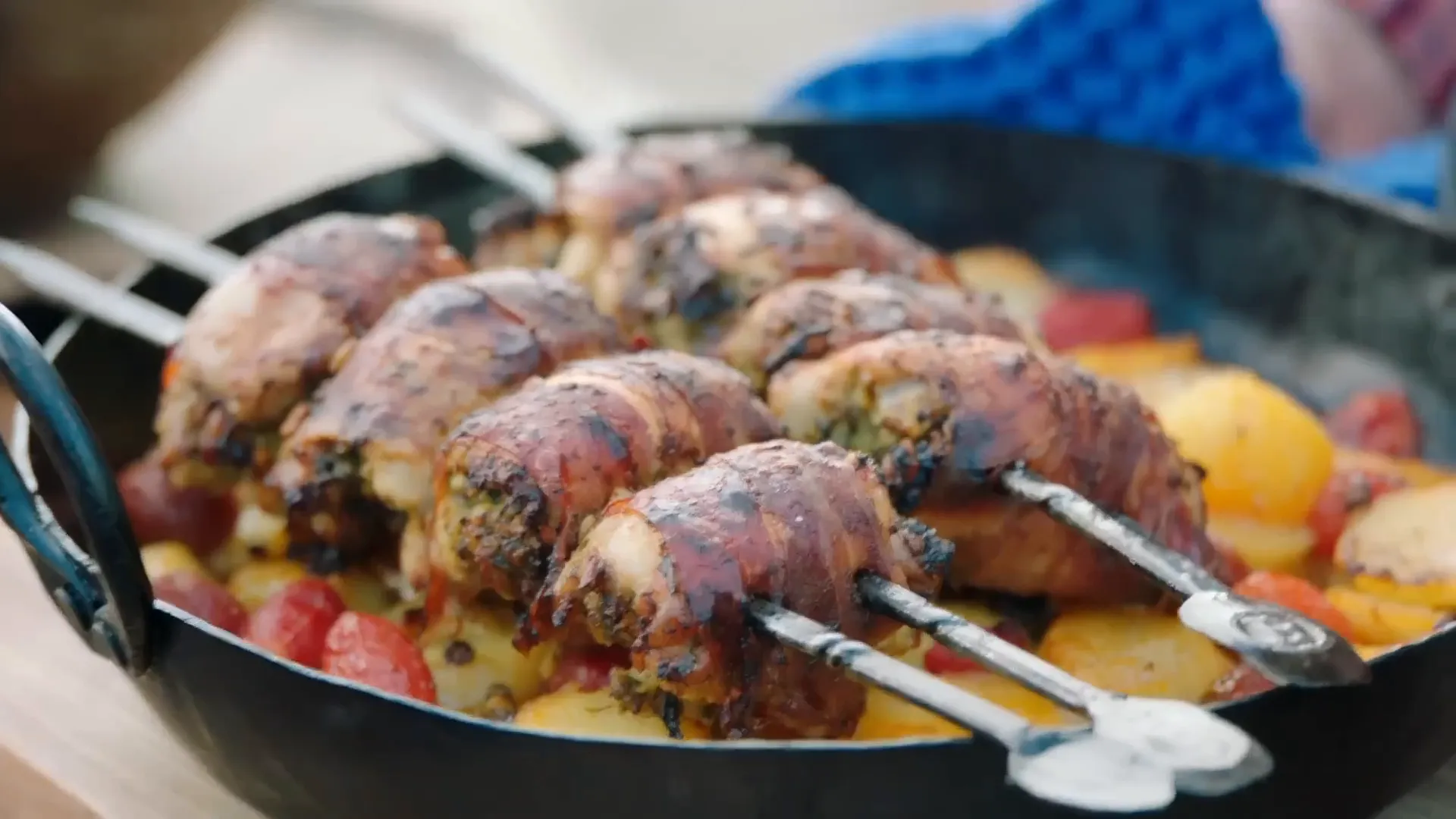 Chicken skewers wrapped in prosciutto over roasted potatoes
