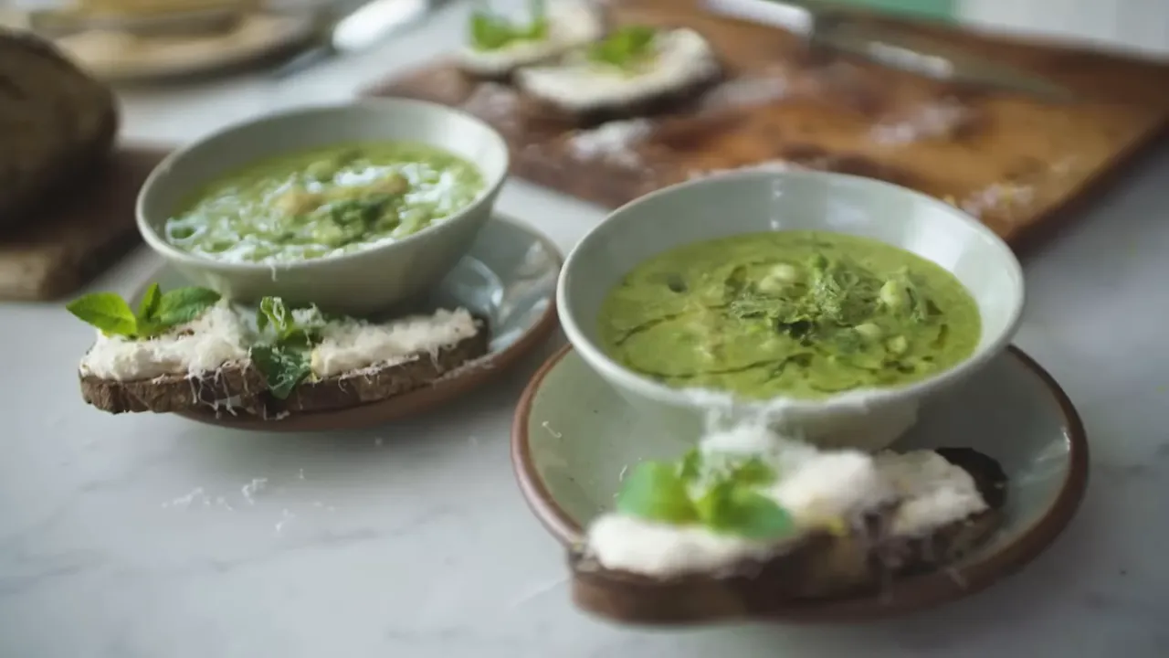 Spring onion soup with whipped ricotta toasts on a rustic table