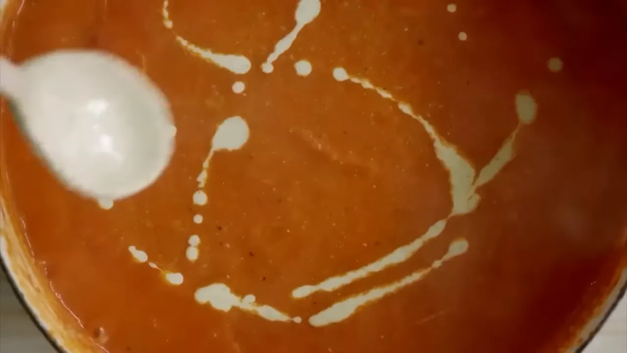 Bright Mexican tomato soup with jalapeno yogurt ribbon