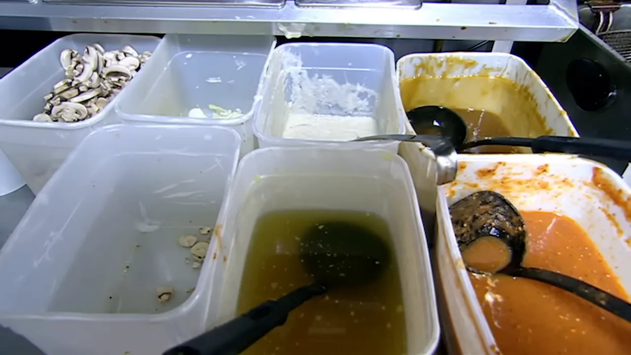 Packed kitchen with microwave and packets of powdered sauce visible
