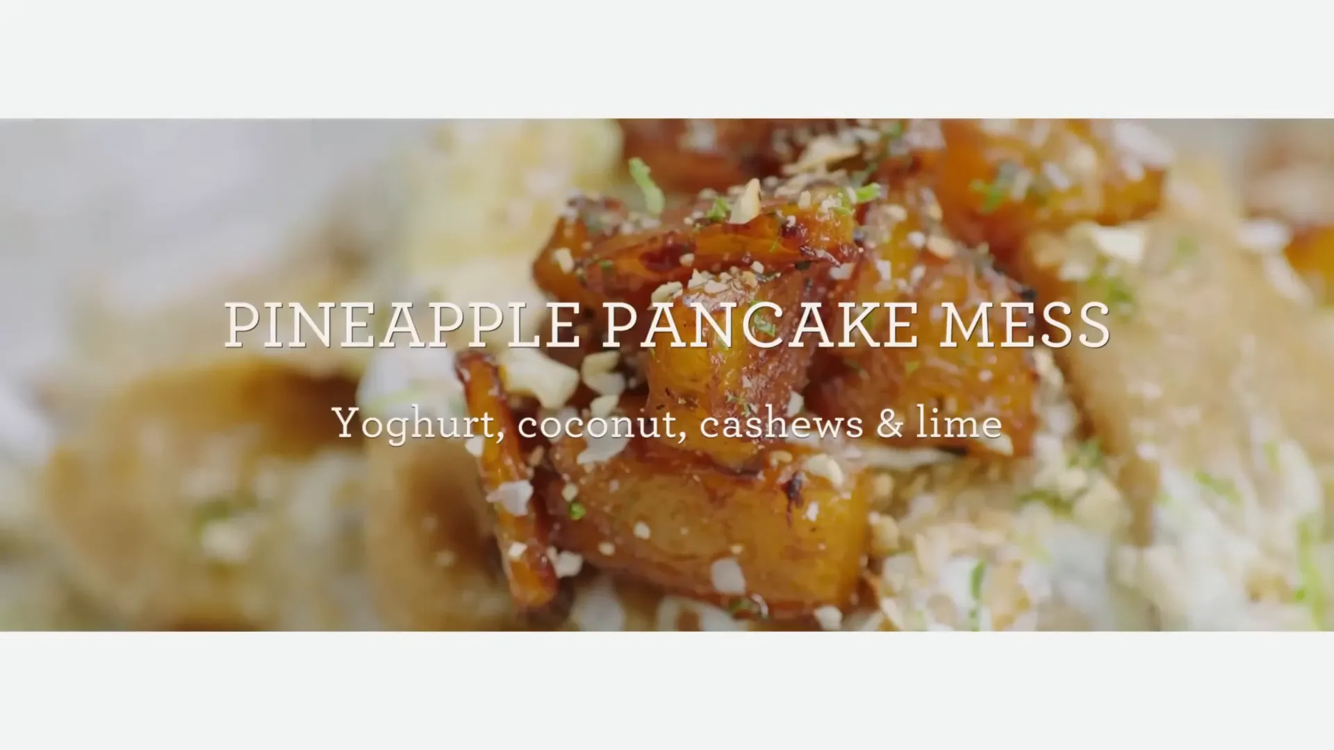 Stack of golden pineapple pancakes with yogurt and nuts