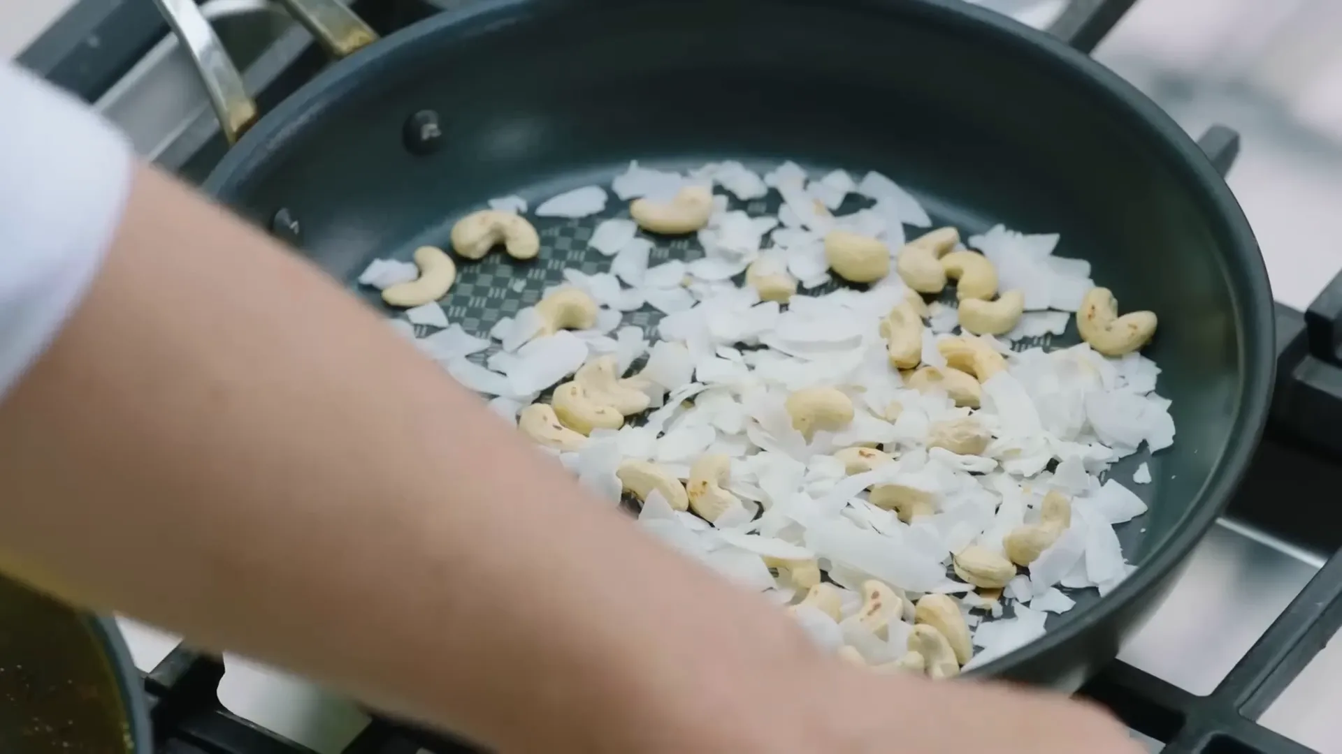 Toasted coconut and cashew nuts ready to be crushed