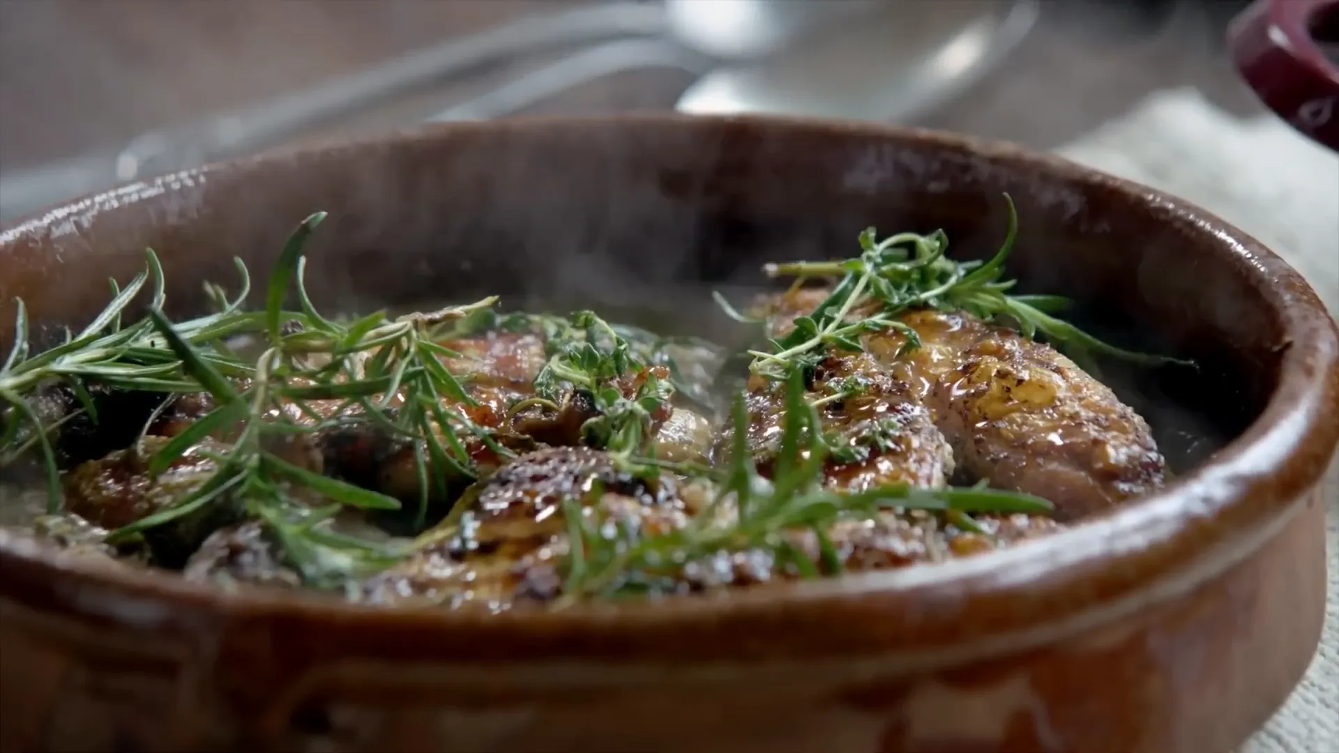 Crispy skinned jerk chicken sizzling on a griddle pan