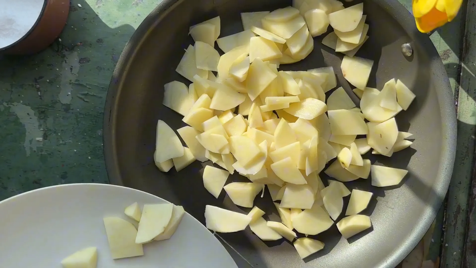 Thinly sliced potatoes ready in a skillet