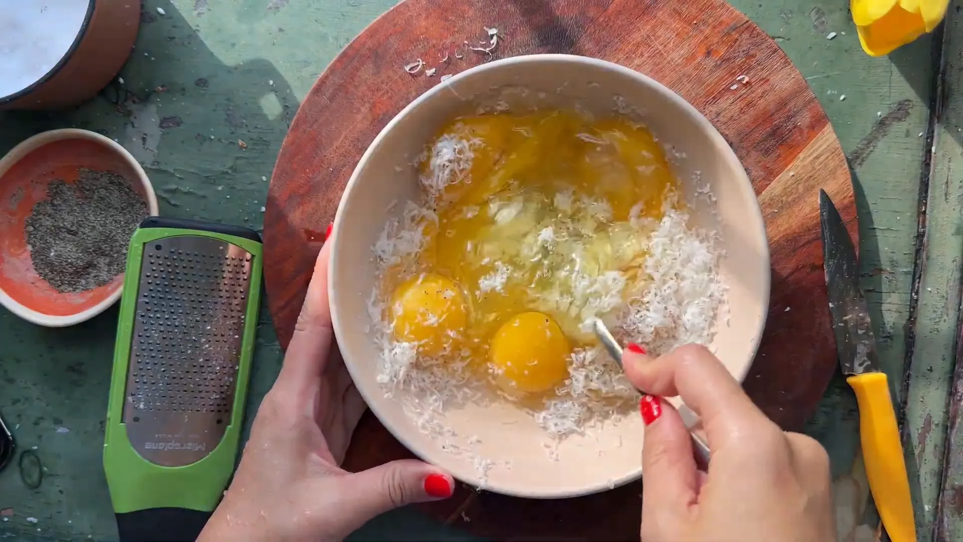 Whisked eggs with grated Parmigiano in a bowl