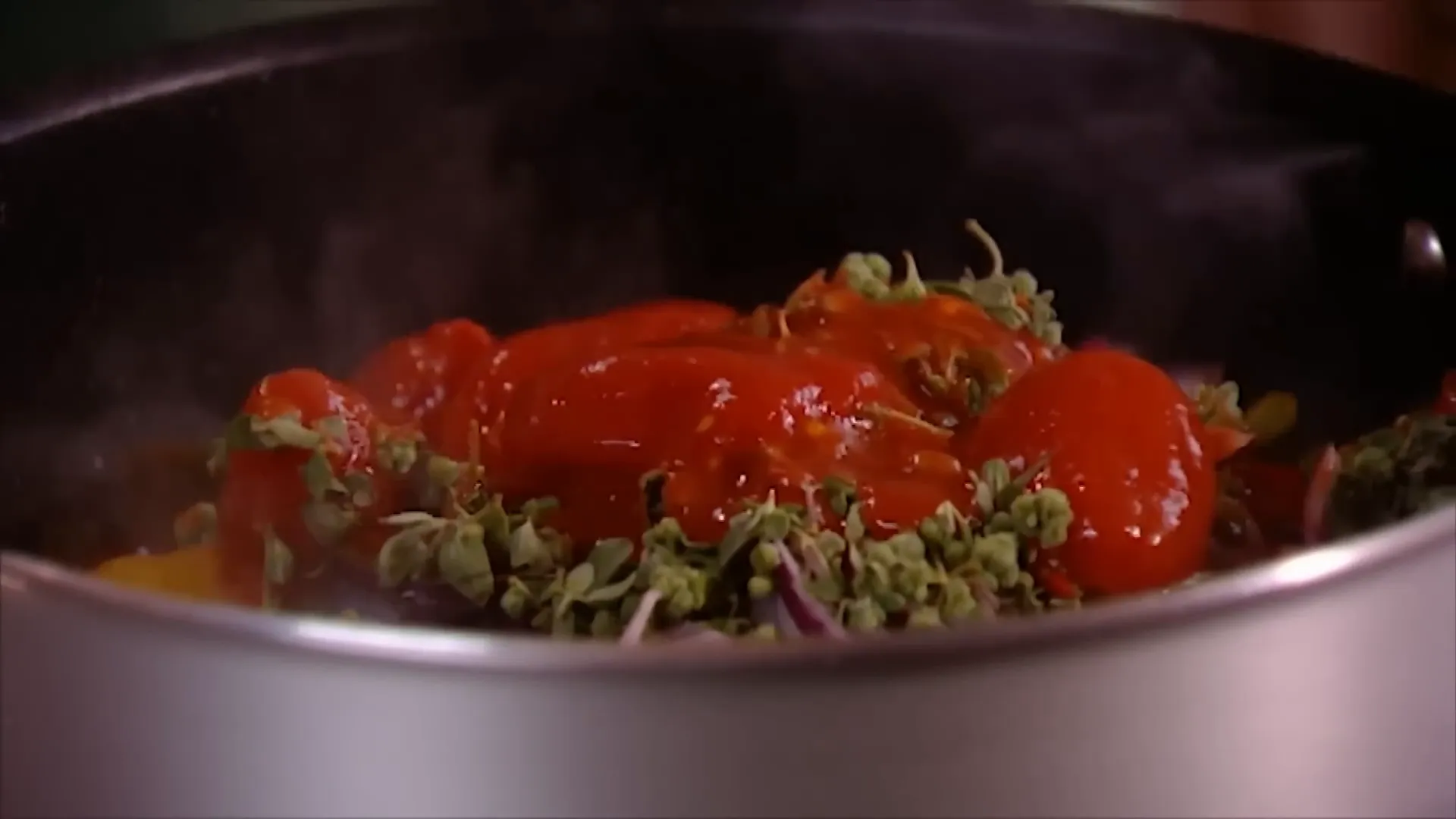 Pouring chopped tomatoes into the pot