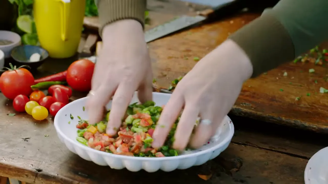 Chopping colourful tomatoes for fresh salsa