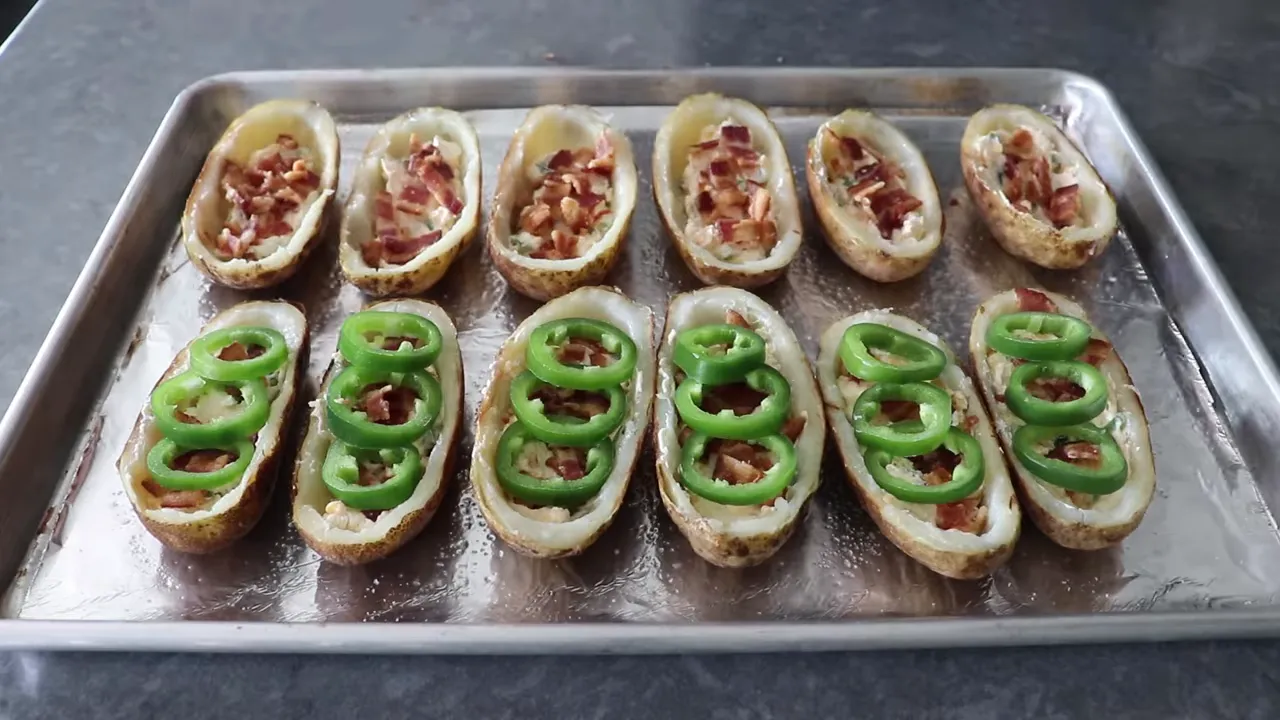 Potato skins filled with cheese and bacon, topped with jalapeno rings before baking
