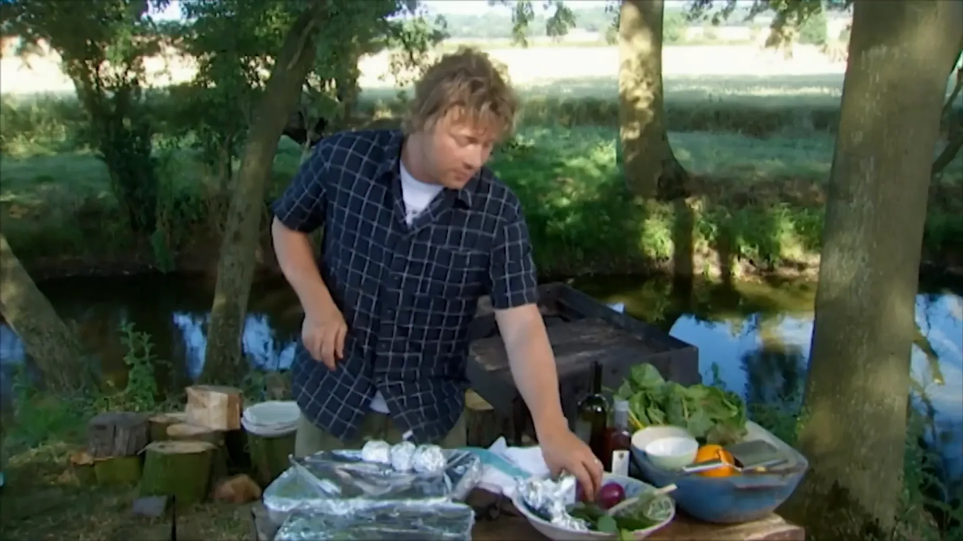 Foil-wrapped onion with herbs ready for barbecue