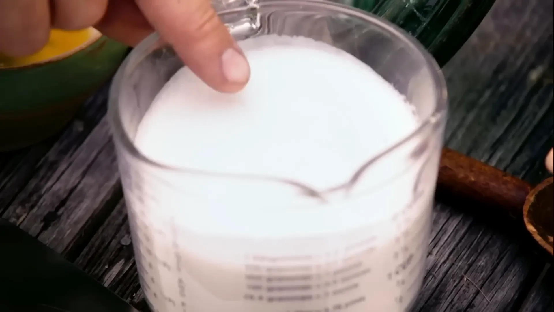 Tepid milk and yeast starting to froth in a bowl