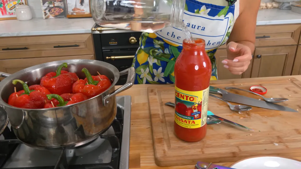 Pot covered and simmering with stuffed peppers and tomato sauce