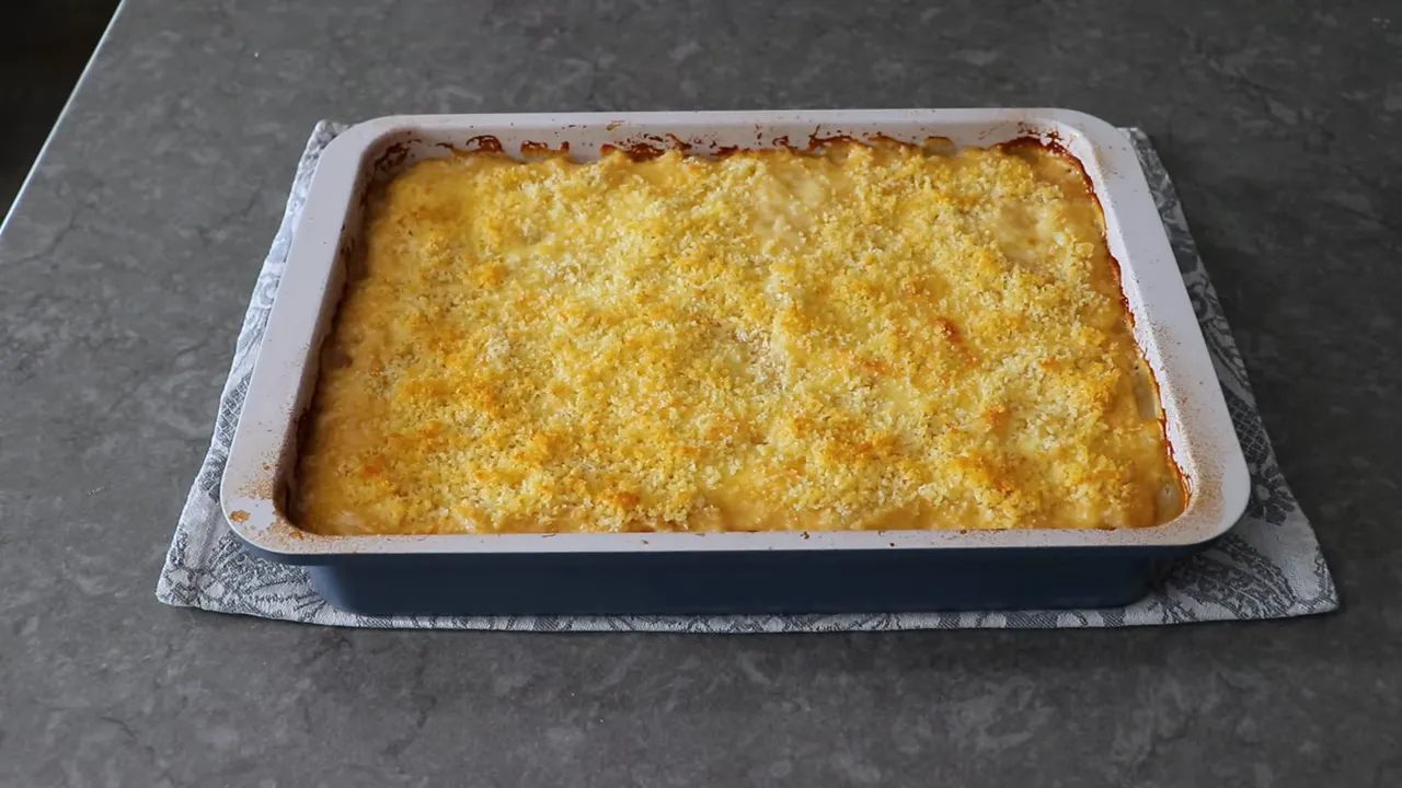 rectangular casserole of Country Club Potatoes with a golden breadcrumb crust on a countertop