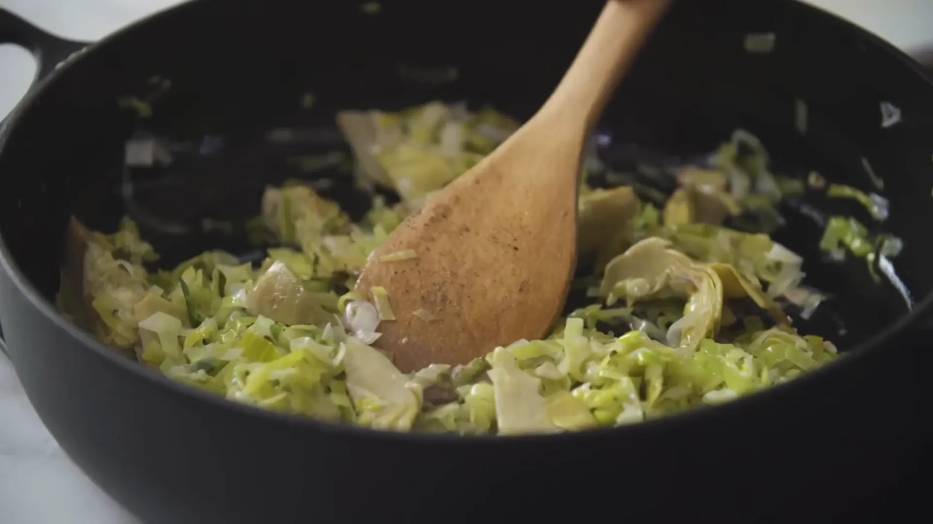 Leeks cooking down in a pan, soft and fragrant