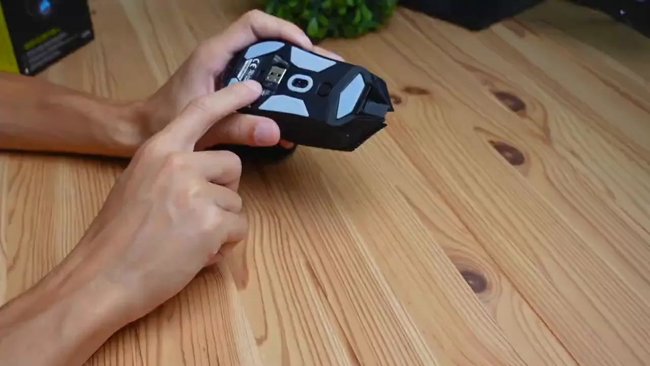 Bottom of the mouse with USB receiver storage compartment visible