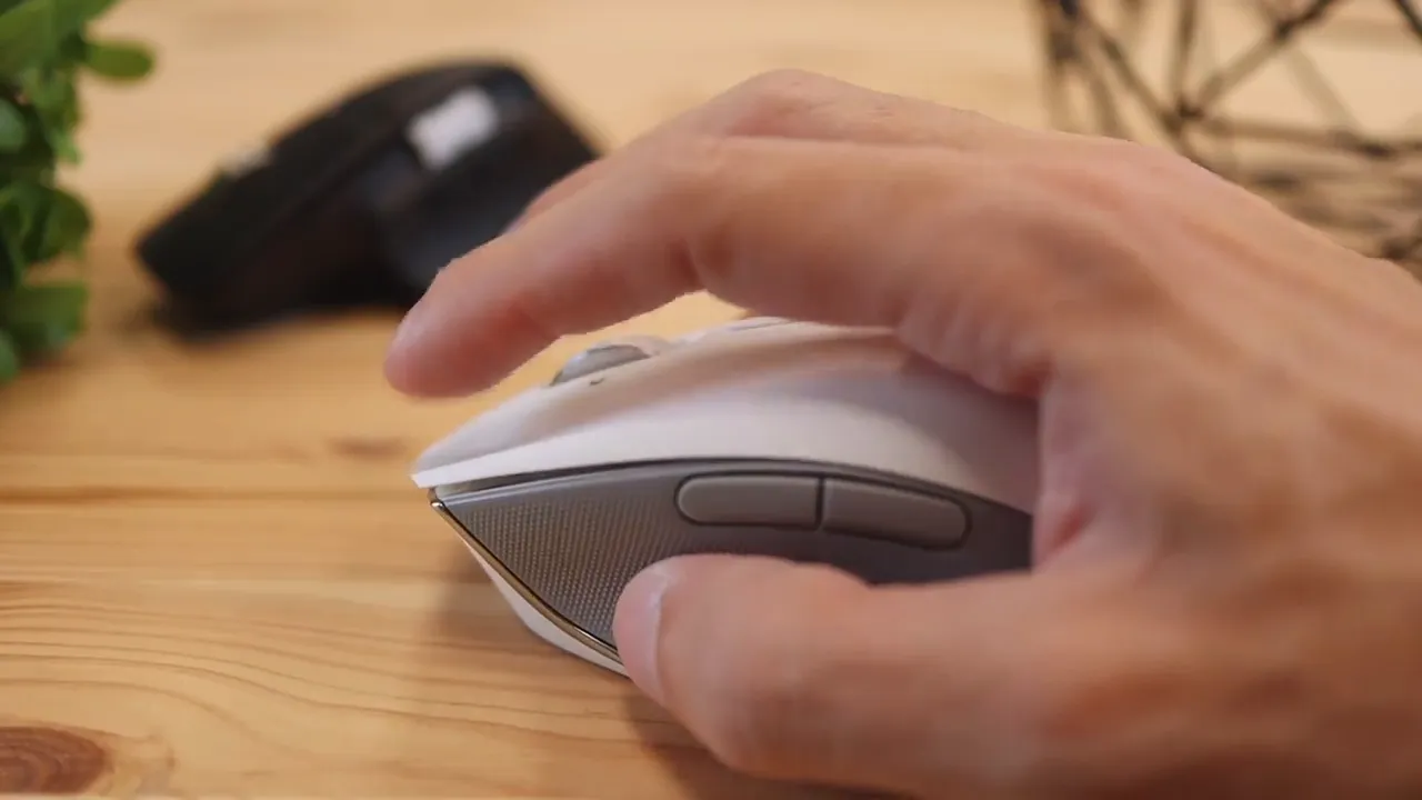 Hand resting on the side of the white Razer Pro Click mouse