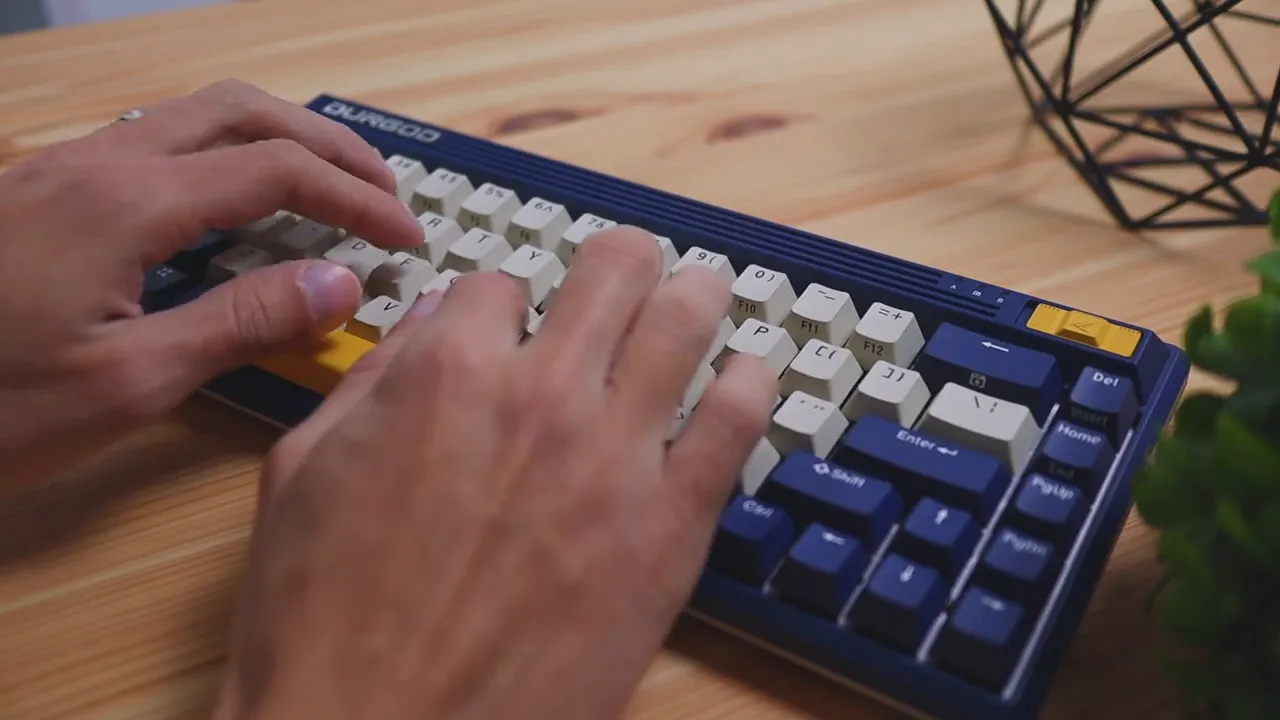 Close-up of hands pressing keys on the Durgod Fusion 65 mechanical keyboard