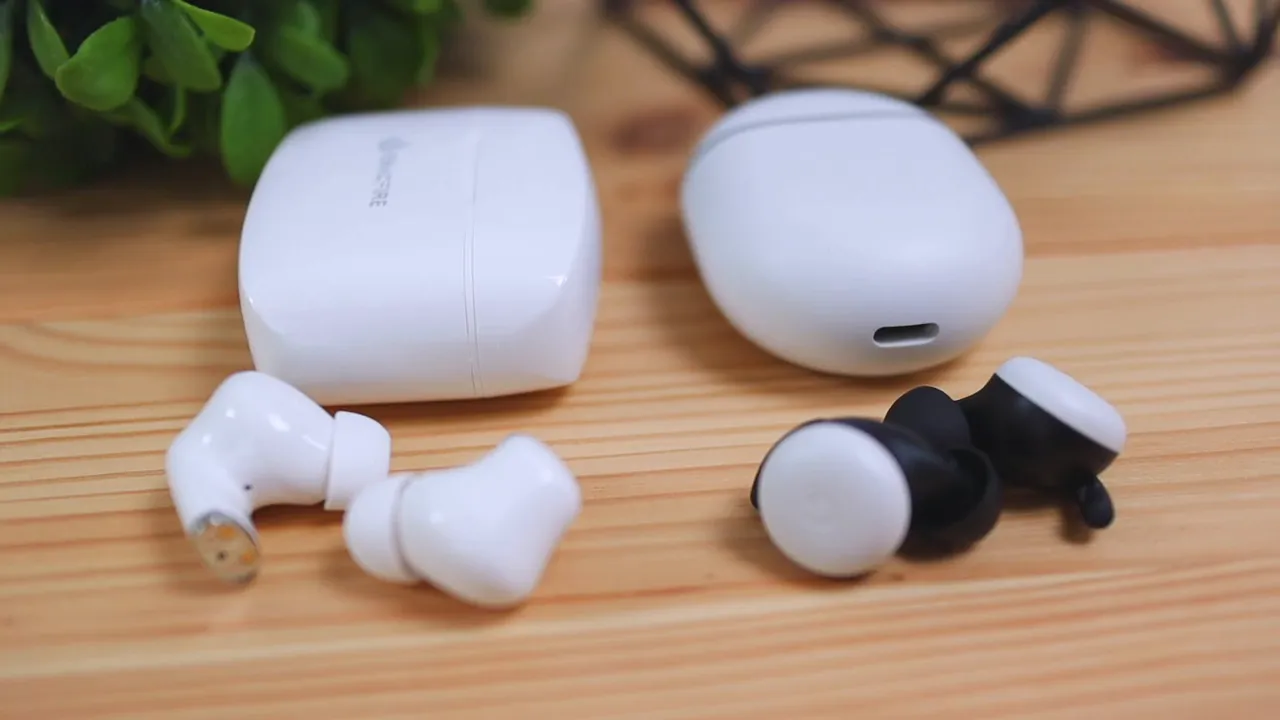 ENACFIRE E90 charging case with earbuds on a wooden surface