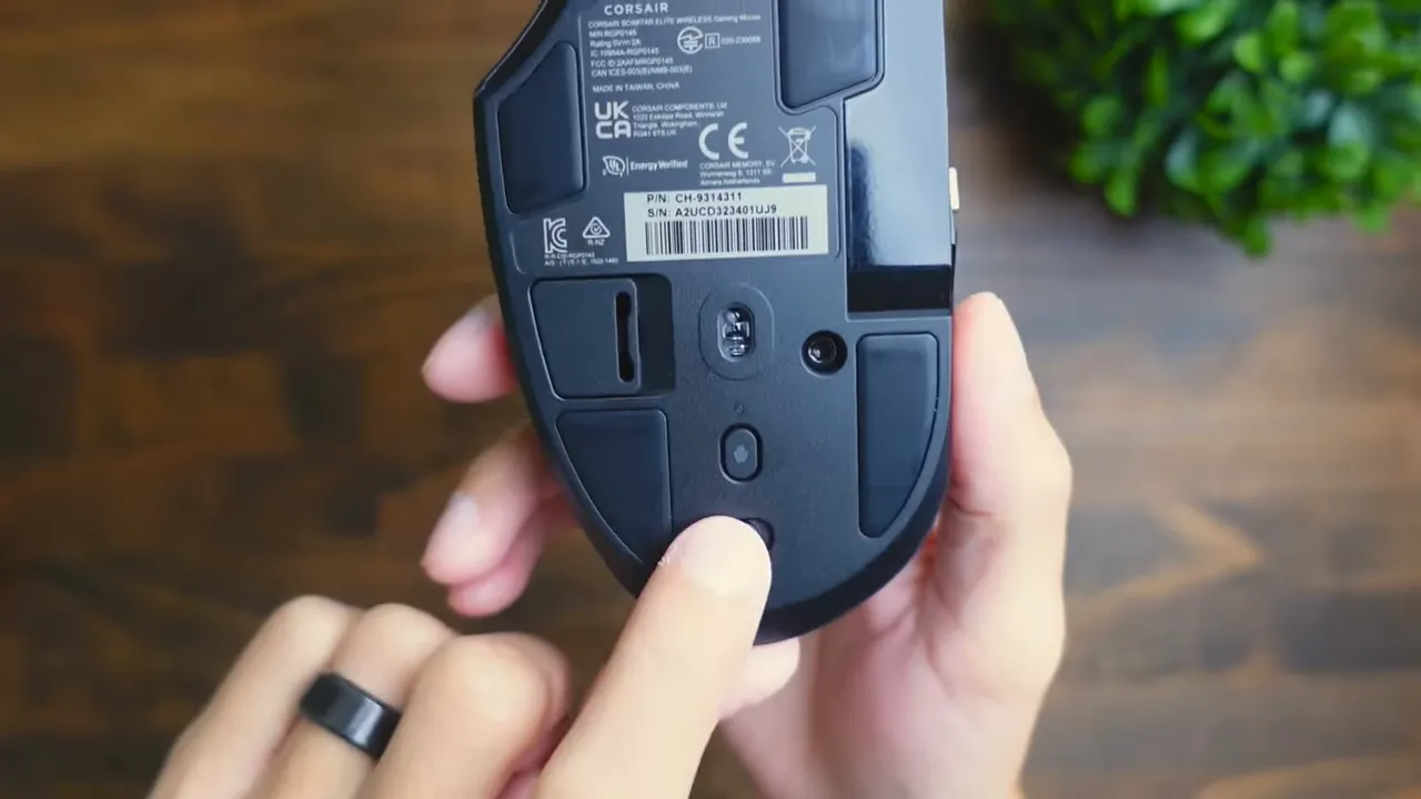 Bottom of the mouse showing skates, sensor and dongle compartment