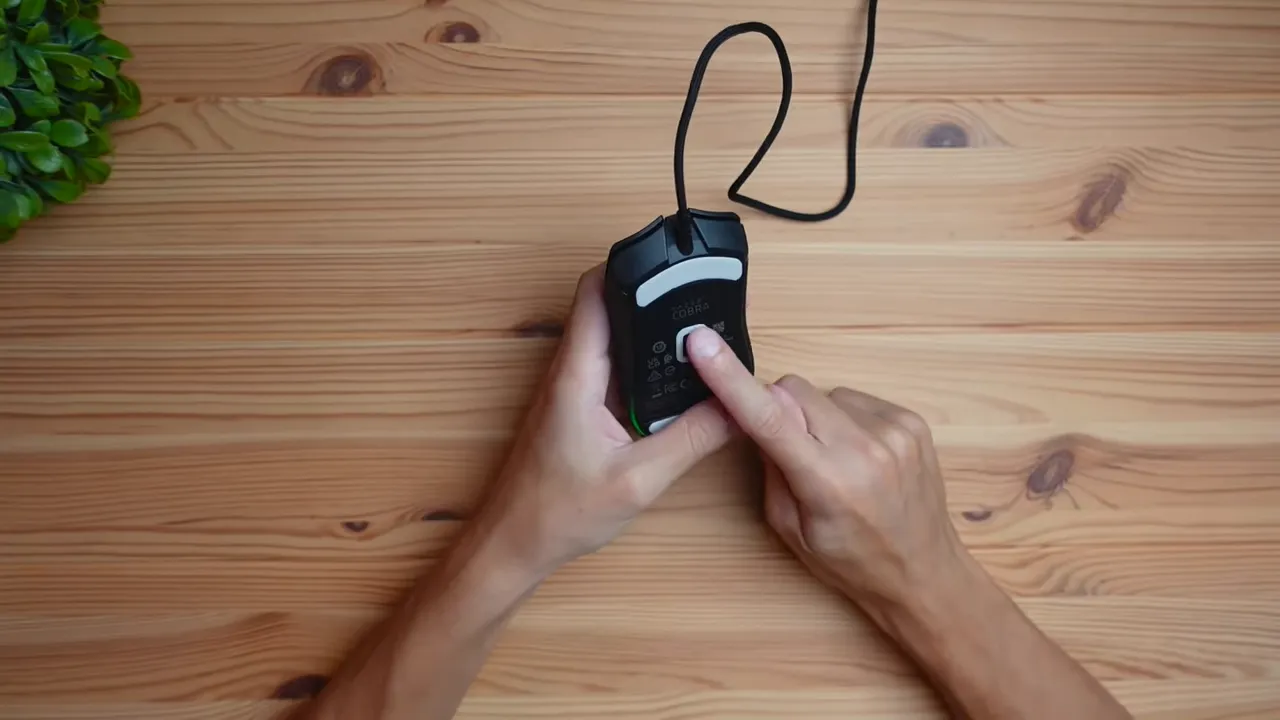 Underside of the mouse showing 8K sensor and PTFE skates