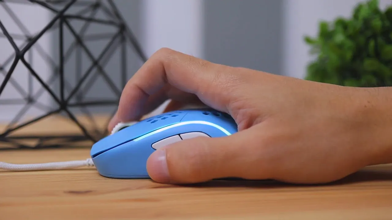 Hand resting naturally on the blue mouse from the side