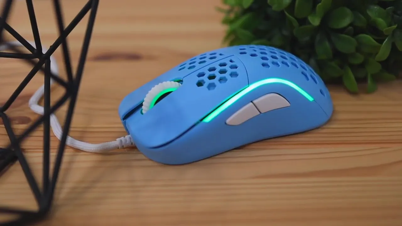 Blue mouse on desk glowing with cyan side lighting and lit scroll wheel