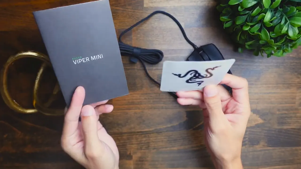 Unboxed contents laid out: mouse, instruction manual, Razer sticker