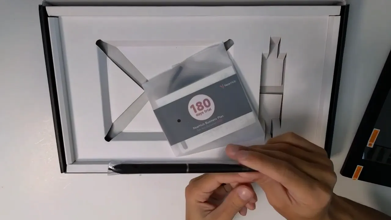 Open NEARHUB S13 box showing the stylus and a 180-day trial/welcome card