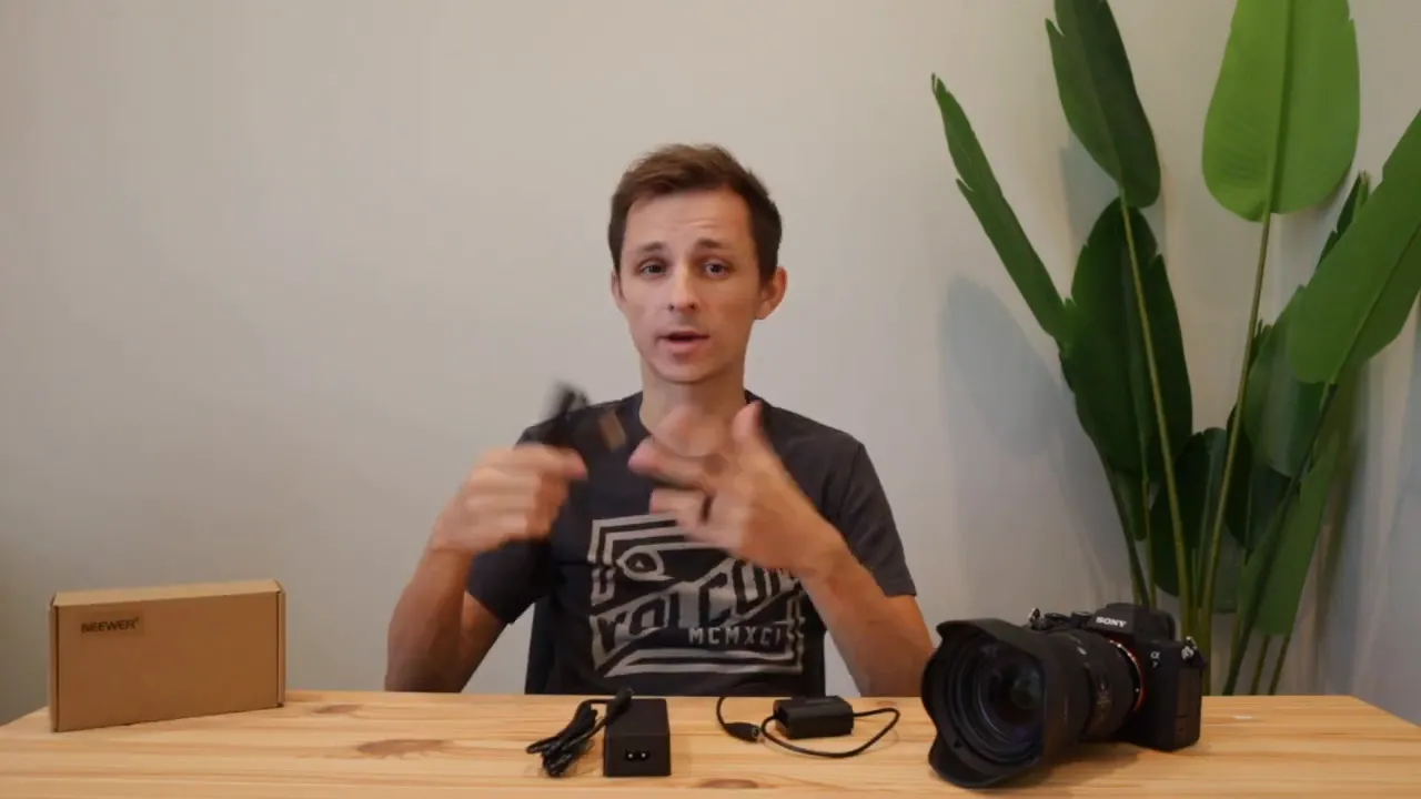 Neewer NP-FZ100 dummy battery kit components and Sony A7IV on a table