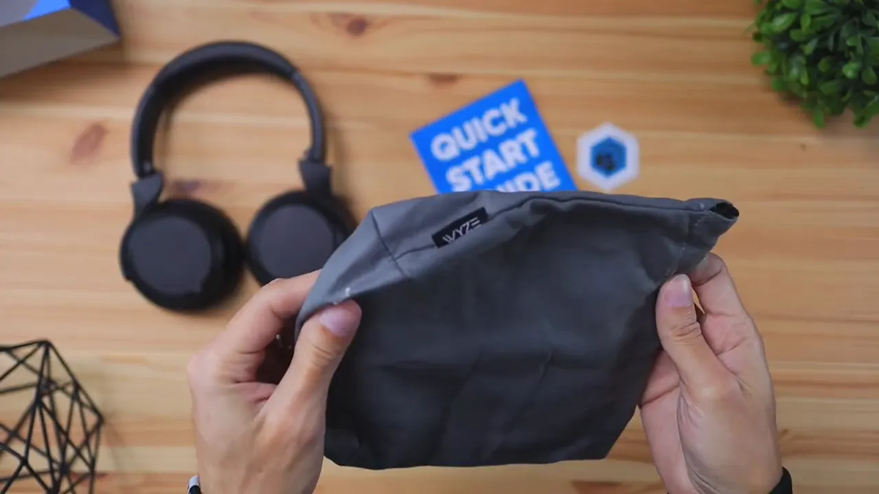 Wyze active noise canceling headphones folded and placed into the carrying bag