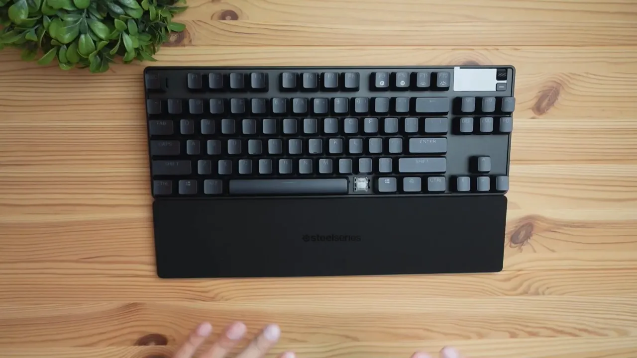 Apex Pro TKL keyboard with magnetic rubberized wrist rest attached on wooden desk