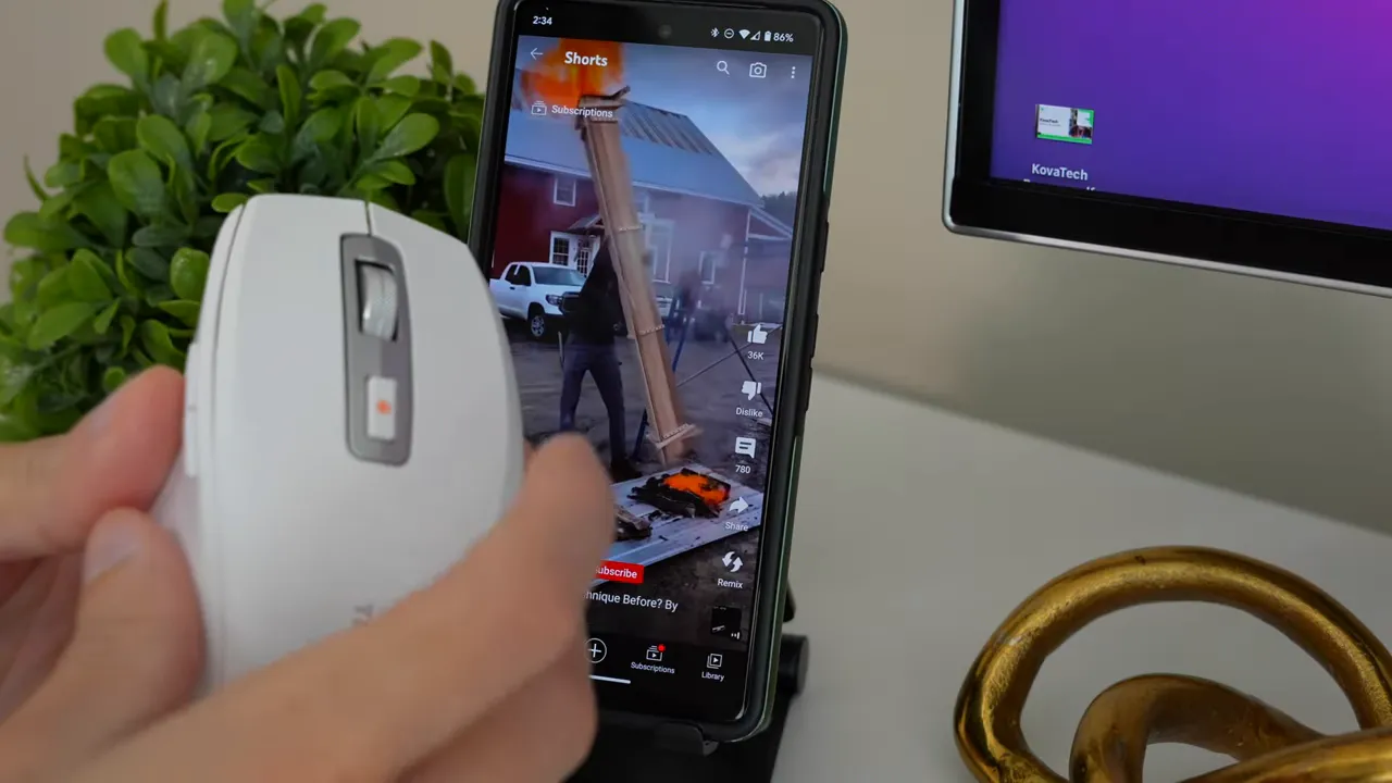 Close view of TMICE TKM01A mouse operating YouTube Shorts on a smartphone