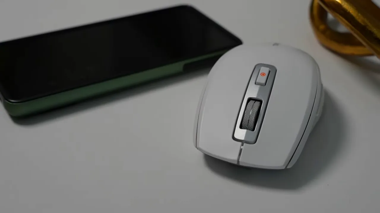 Close-up top view of the TMICE mouse showing the textured metal scroll wheel and compact profile