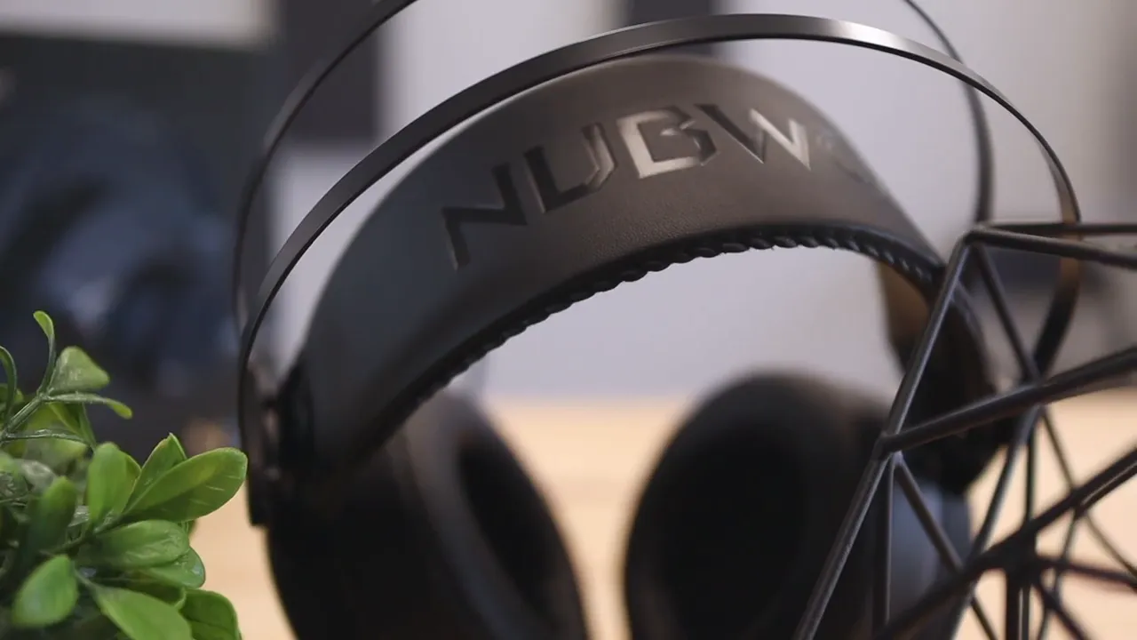 Nubwo N7 headset hanging on a stand with dual metal support bands and oval ear cups
