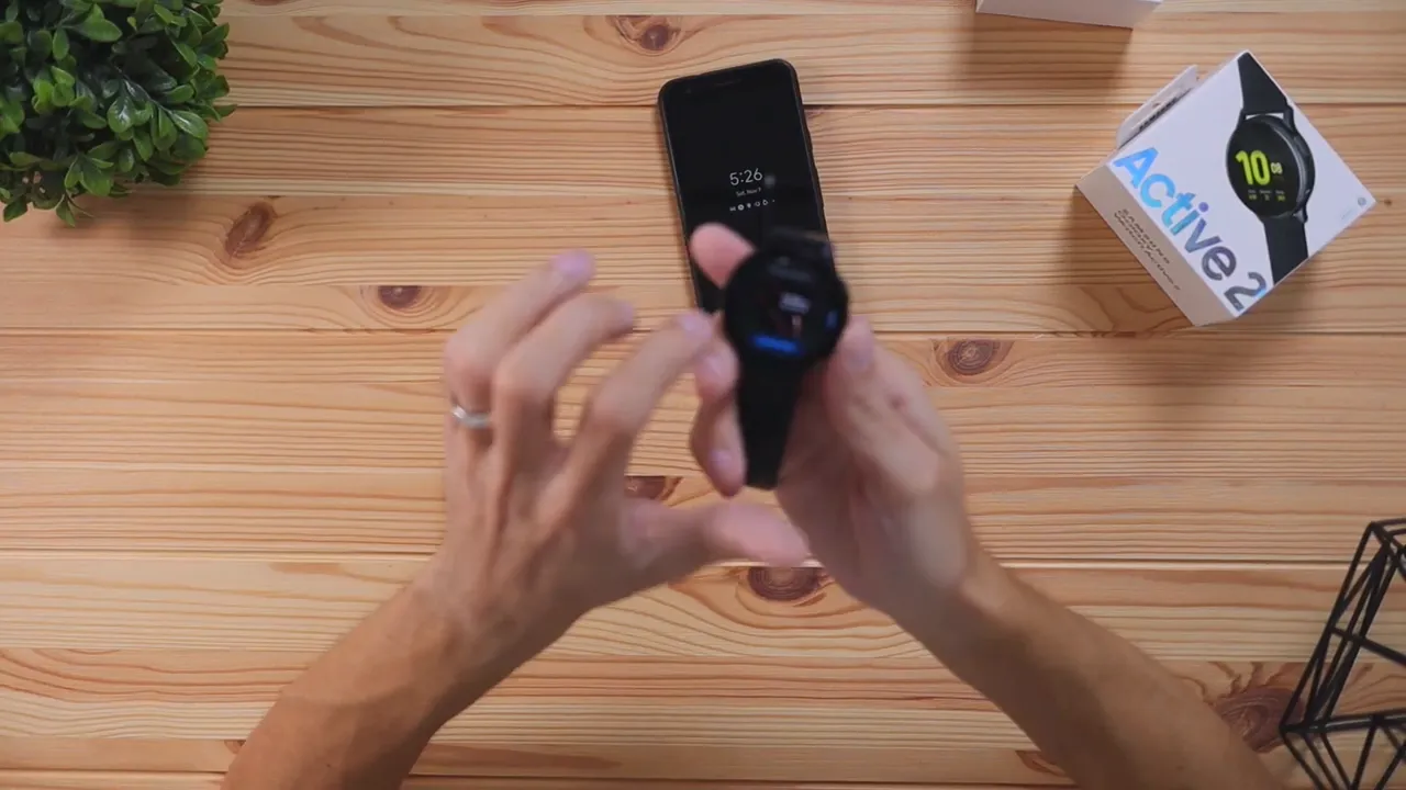 Samsung Galaxy Watch Active 2 watch face on display while holding the watch up
