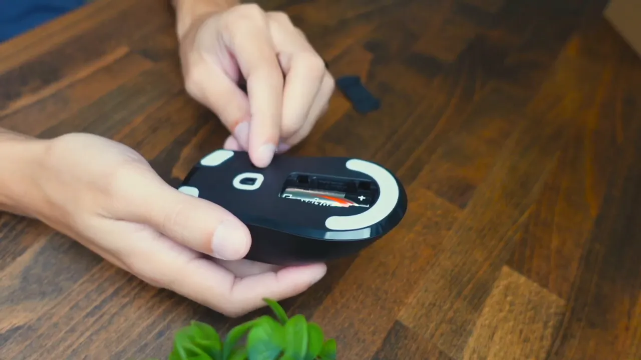 Battery compartment being opened and AA battery inserted