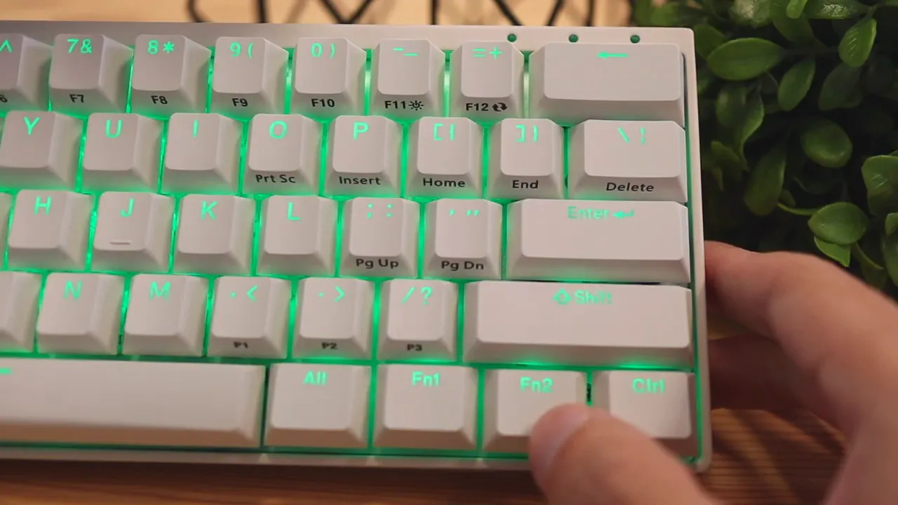 Close-up of the keyboard corner while a hand cycles RGB modes and colors