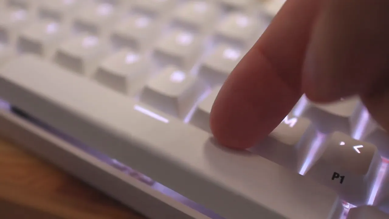 Close-up of a finger pressing the white spacebar