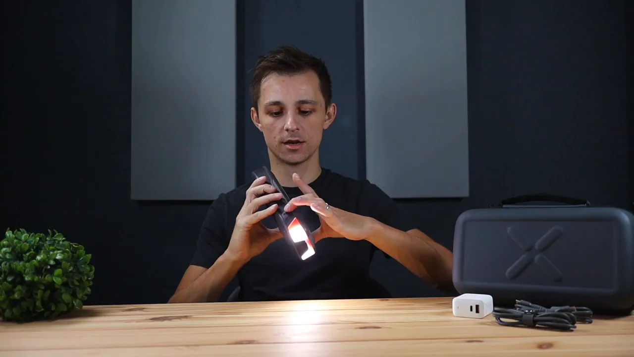 Hands adjusting the T8 APEX while its LED light shines on the table to demonstrate modes