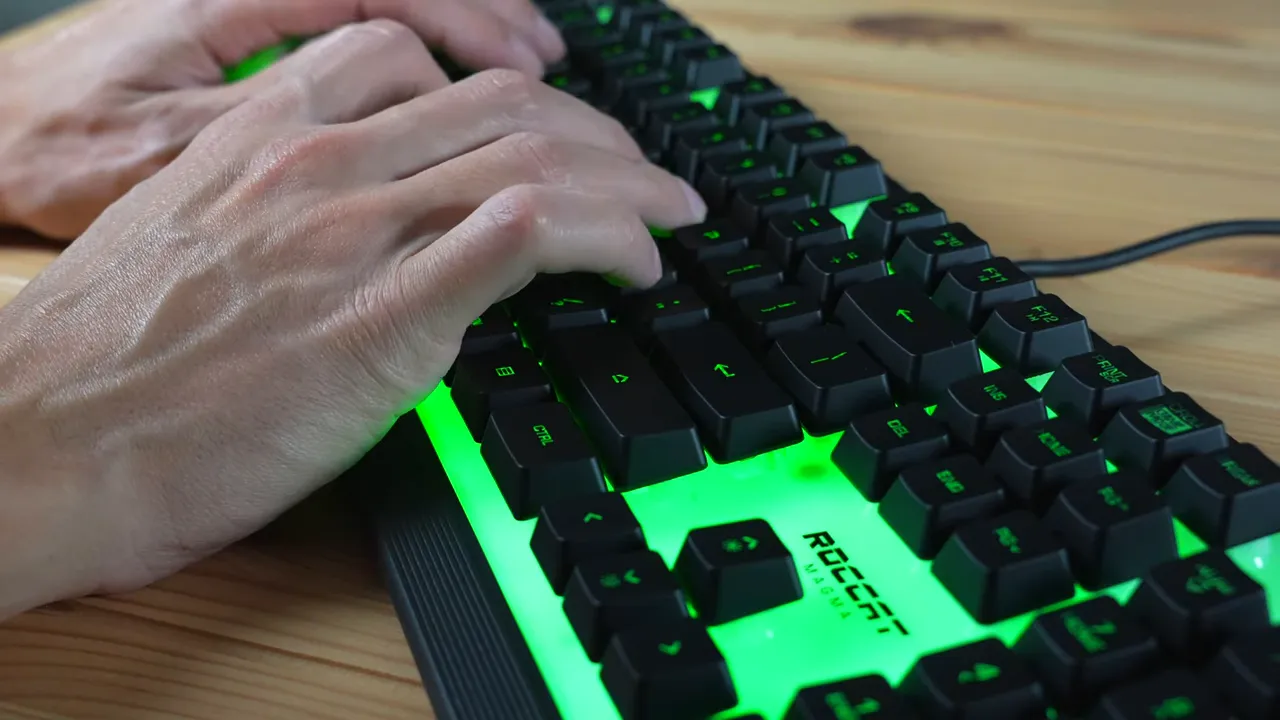 Close-up of Roccat Magma keyboard showing fixed USB-A cable and green backlight