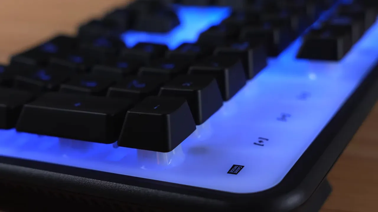 Close-up of Roccat Magma keyboard showing the white backlight plate and bright blue RGB lighting under the keycaps.