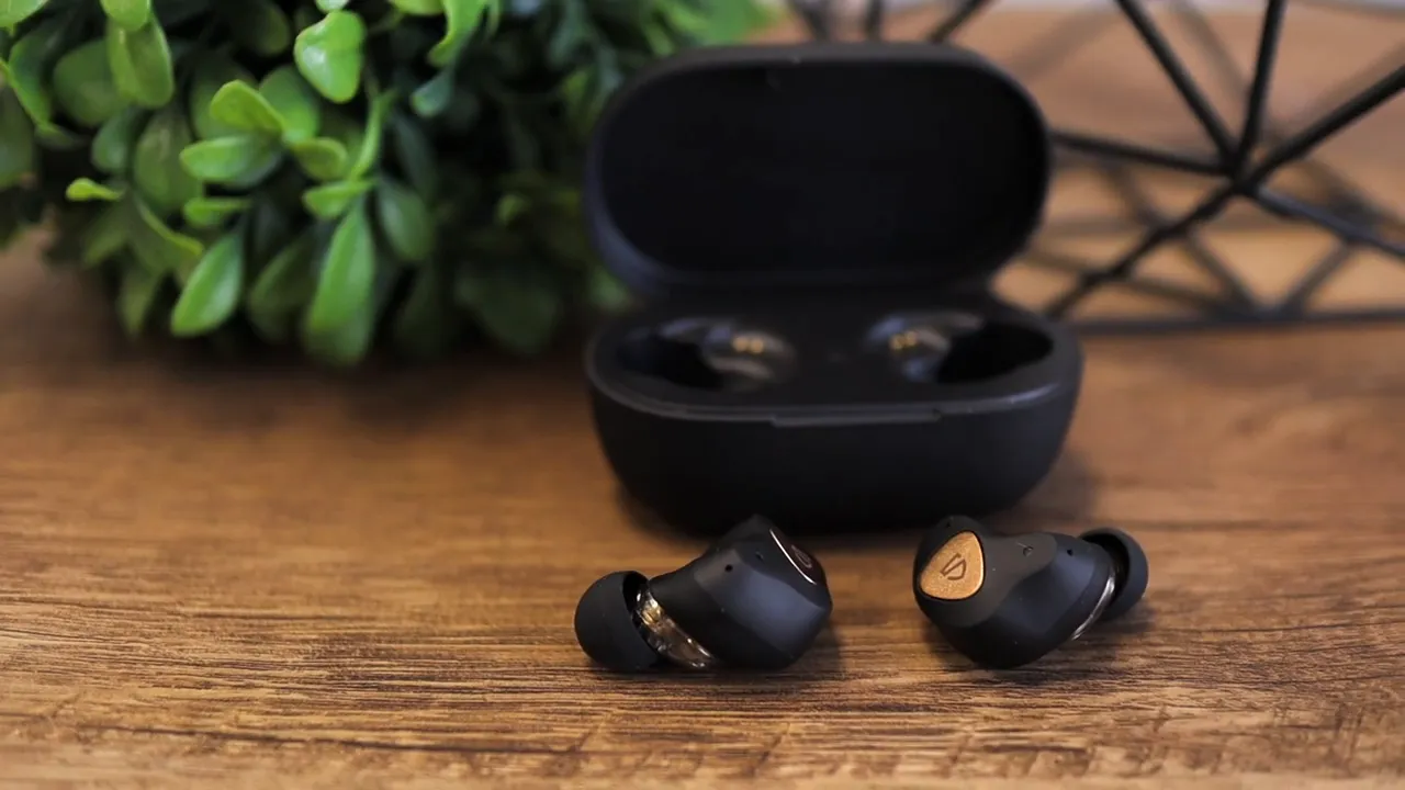 SoundPEATS Sonic wireless earbuds with charging case open on a wooden table