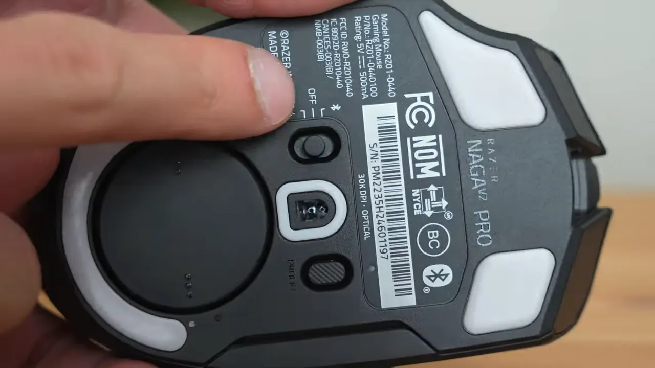 Close-up of Razer Naga V2 Pro underside showing power and mode switch and labels